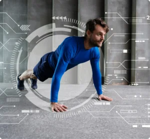 A man doing push ups in front of a computer screen