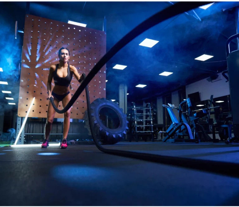 Woman working out in a gym with a rope